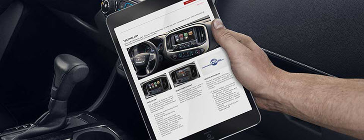 Image of a man's hand holding a tablet connected to the 4G Wi-Fi Hotspot available in the 2017 GMC Canyon pickup truck.