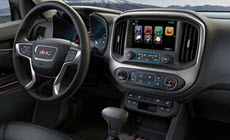 Image of the 8-inch-diagonal Color Touch Radio, dashboard, and steering wheel in the 2017 GMC Canyon pickup truck.