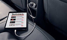 Image of a tablet plugged into the 12 volt charging port on the rear of the center console in the 2017 GMC Canyon.