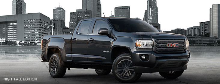 Image of the 2017 GMC Canyon Nightfall Edition parked in front of a cityscape.